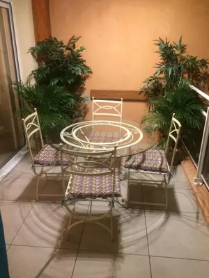 a table and two chairs and a table and some plants at ajaccio Sanguinaires in Ajaccio