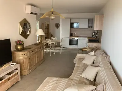 a living room with a couch and a kitchen at ajaccio Sanguinaires in Ajaccio