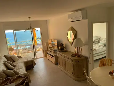 a living room with a couch and a bed and a mirror at ajaccio Sanguinaires in Ajaccio
