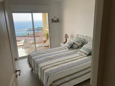 a bedroom with a bed with a view of the ocean at ajaccio Sanguinaires in Ajaccio