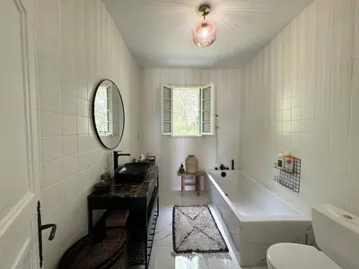 a white bathroom with a tub and a sink at VILLA A MUREDDA, piscine chauffée et vue mer in Olmeto