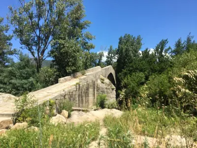 an old stone bridge with a tree in the background at PROCHE du PONT GENOIS in Sartène
