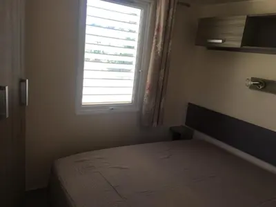 a bedroom with a bed and a window at PROCHE du PONT GENOIS in Sartène