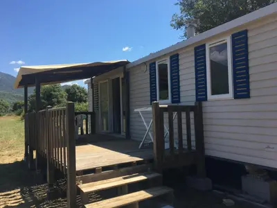 a tiny house with a porch and a deck at PROCHE du PONT GENOIS in Sartène