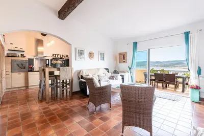 a living room with a couch and a table at Terra Di Sole - Vue mer et montagne in Grosseto-Prugna