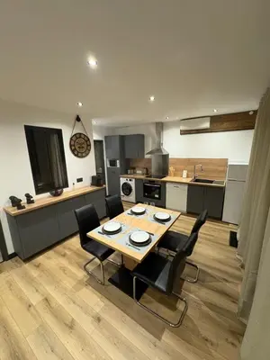 a kitchen with a table and chairs in a kitchen at T3 - 100m du port in Propriano