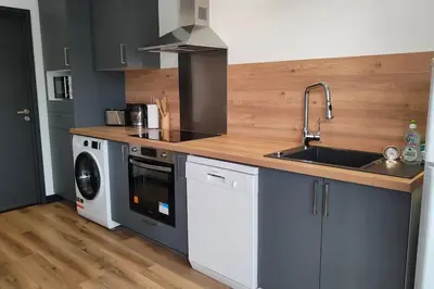 a kitchen with a sink and a washing machine at T3 - 100m du port in Propriano