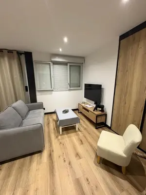 a living room with a couch and a tv at T3 - 100m du port in Propriano