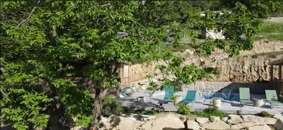 a group of chairs sitting next to a wall at Chalet U Pinu in Venaco