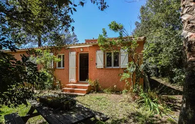 a red brick house with a front door and trees at 2 Bedroom Lovely Home In Piscia Rossa in Afa