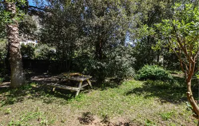 a picnic table and a bench in a garden at 2 Bedroom Lovely Home In Piscia Rossa in Afa