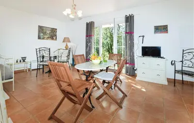 a dining room and living room with a table and chairs at Stunning Home In Afa With Wifi in Afa