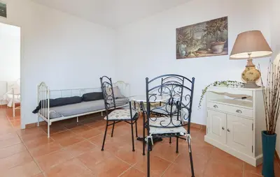 a living room with a table and chairs and a couch at Stunning Home In Afa With Wifi in Afa