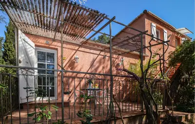 a house with a iron fence in front of it at Cozy Home In Piscia Rossa With Wifi in Afa