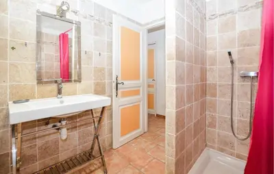 a bathroom with a sink and a shower at Cozy Home In Piscia Rossa With Wifi in Afa