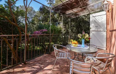 a patio with a table and chairs and a fence at Cozy Home In Piscia Rossa With Wifi in Afa
