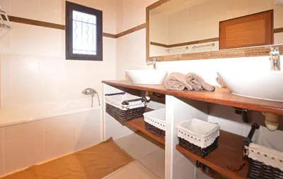 a bathroom with a sink and a tub and a mirror at Nice Home In Sagone With Wi-Fi in Sagone