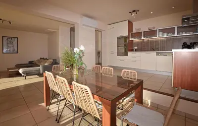 a dining room and kitchen with a glass table and chairs at Nice Home In Sagone With Wi-Fi in Sagone