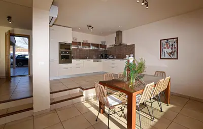 a kitchen and dining room with a table and chairs at Nice Home In Sagone With Wi-Fi in Sagone