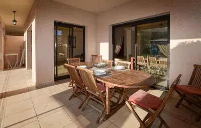 a dining room with a wooden table and chairs at Nice Home In Sagone With Wi-Fi in Sagone