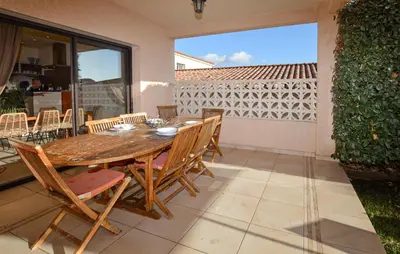 a wooden table and chairs on a patio at Nice Home In Sagone With Wi-Fi in Sagone