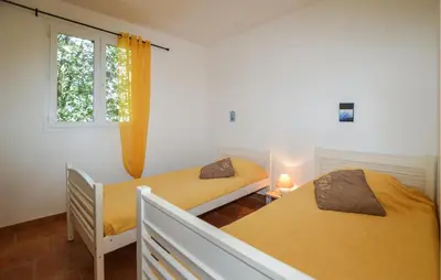 a bedroom with two beds and a window at 2 Bedroom Stunning Apartment In Afa in Afa