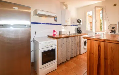 a kitchen with a white stove and a refrigerator at 2 Bedroom Stunning Apartment In Afa in Afa