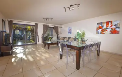 a living room with a dining room table and chairs at Beautiful Home In Sagone With Kitchen in Sagone