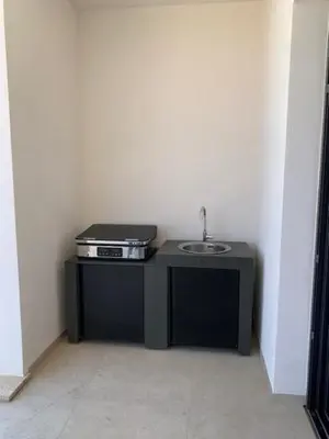a small black table with a sink in a room at VILLA RIVOLI vue mer et piscine in Pietrosella