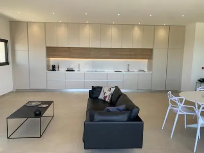 a living room with a couch and a table at VILLA RIVOLI vue mer et piscine in Pietrosella
