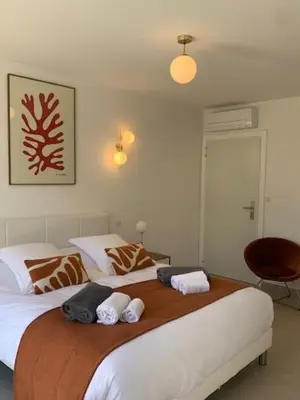 a bedroom with two beds with towels on them at VILLA NAPOLEON vue mer et piscine in Pietrosella