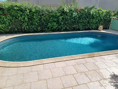 a small swimming pool with blue water in a yard at Maison de campagne piscine et jardin privatifs près de la plage in Aléria