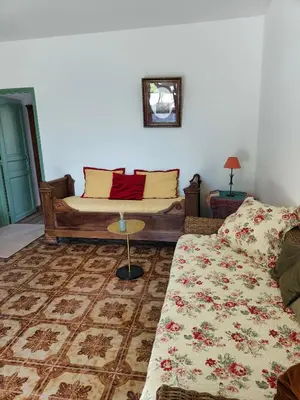 a living room with a couch and a table at Maison de campagne piscine et jardin privatifs près de la plage in Aléria