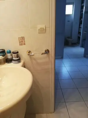 a bathroom with a white toilet and a sink at Appartement 3 chambres - 2 salles de bain - 6 personnes in Ajaccio