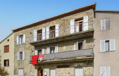 an old brick building with a balcony on it at Lovely Apartment In Poggio Di Nazza in Poggio-di-Nazza