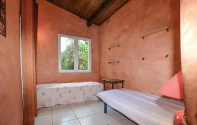 a bedroom with a bed and a window at Lovely Apartment In Poggio Di Nazza in Poggio-di-Nazza