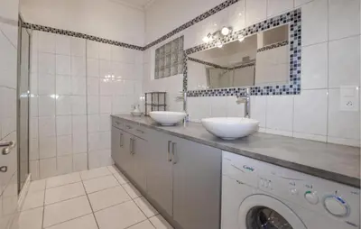 a bathroom with two sinks and a washing machine at Lovely Apartment In Poggio Di Nazza in Poggio-di-Nazza