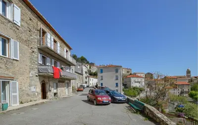 a street with two cars parked on the side at Lovely Apartment In Poggio Di Nazza in Poggio-di-Nazza