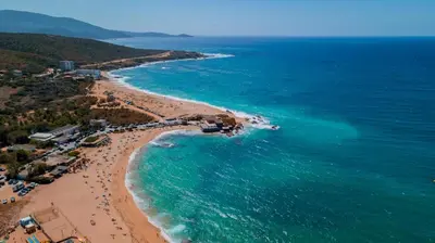 an aerial view of a beach with people in the water at Appartement avec terrasse 3 pièces - Vue mer - Plage 5 min à pied in Propriano