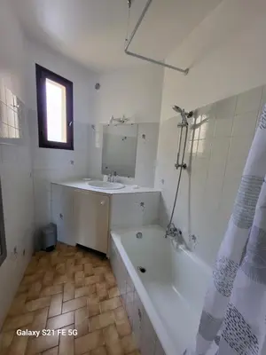 a bathroom with a bath tub and a sink at T2 bord de mer Agosta in Albitreccia