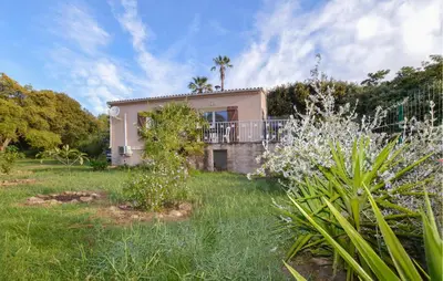 a house with a balcony in a yard at 2 Bedroom Stunning Home In San-Giuliano in San-Giuliano