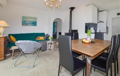 a living room with a table and a couch at 2 Bedroom Stunning Home In San-Giuliano in San-Giuliano