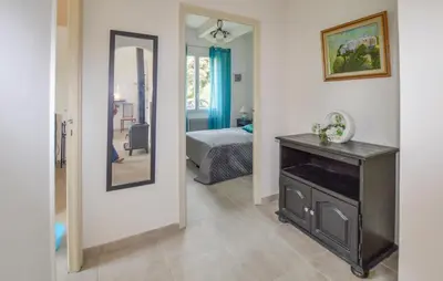a room with a mirror and a bedroom with a bed at 2 Bedroom Stunning Home In San-Giuliano in San-Giuliano