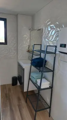 a shelf in a room with a desk at Maison proche de la mer in Pianottoli-Caldarello