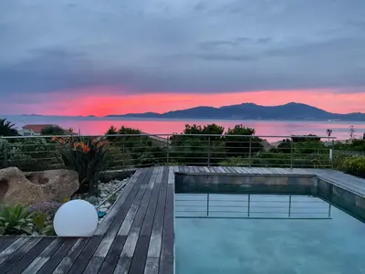 a swimming pool on a deck with a view of the ocean at villa 4 etoiles 3 chambres vue mer ajaccio in Pietrosella