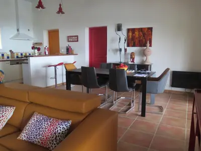 a living room with a couch and a table with chairs at villa 4 etoiles 3 chambres vue mer ajaccio in Pietrosella