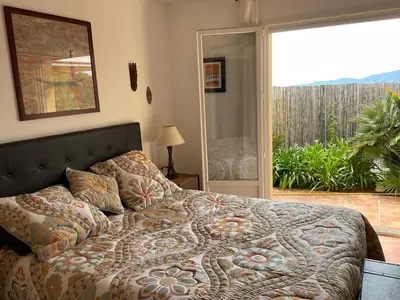 a bedroom with a bed and a sliding glass door at villa 4 etoiles 3 chambres vue mer ajaccio in Pietrosella