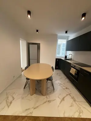 a kitchen with a wooden table in a room at Appartement Ajaccio hyper centre in Ajaccio