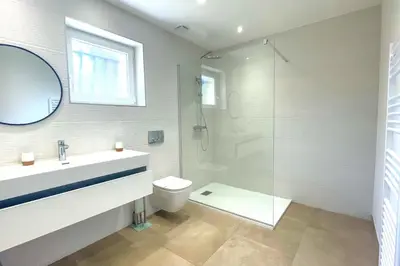 a bathroom with a shower and a sink and a toilet at Villa Amaredda Di Arasu in Sainte-Lucie de Porto-Vecchio