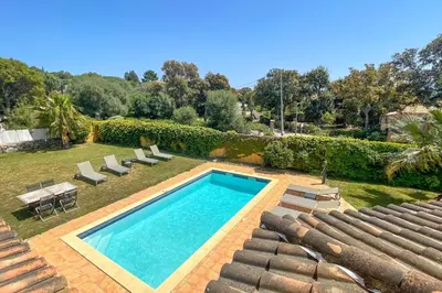 a swimming pool with chaise lounge chairs and a swimming pool at Villa Amaredda Di Arasu in Sainte-Lucie de Porto-Vecchio